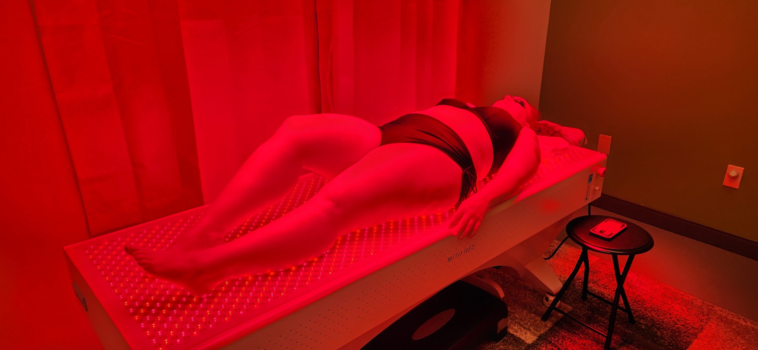 Woman in bikini during red light therapy session at Linde Esthetics& Wellness Studio in Springfield MO